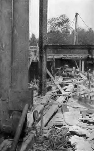 FIG. 9. UNPROTECTED HOISTING ENGINE, CABLES, AND GUIDE BLOCKS.