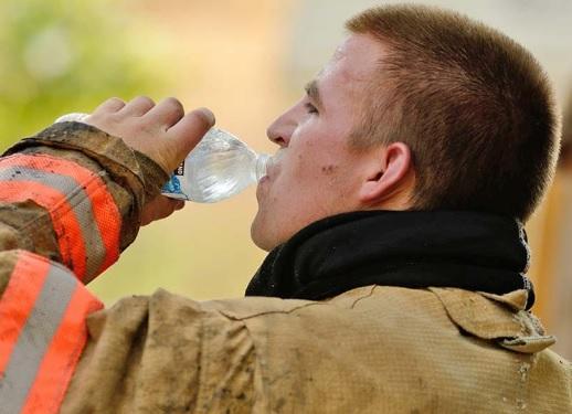 A firefighter takes a break during a training exercise. Firefighters and other First Responders are often at high risk of heat stroke and heat exhaustion, especially during the summer months.
