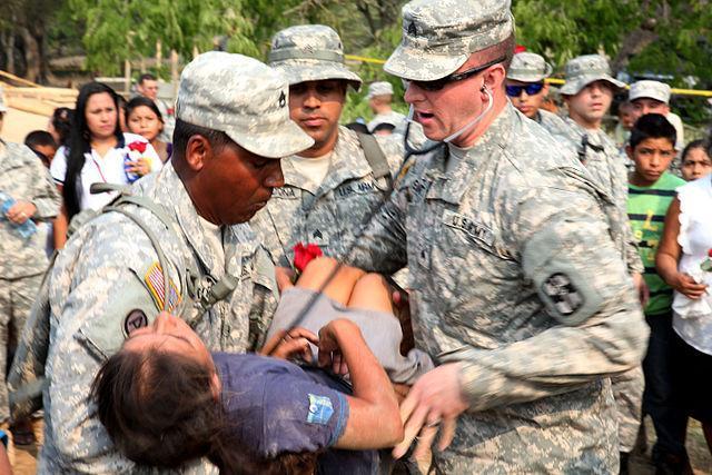 U.S. Army medics assist a Guatemalan woman who passed out from heat stroke during Operation Beyond the Horizon 2014, Zacapa, Guatemala, April 25, 2014. Beyond the Horizon is an annual exercise that embraces the partnership between the U.S. and Guatemala, to provide focused humanitarian assistance through various medical, dental and civic action programs. 